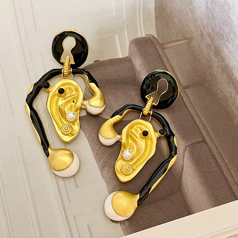Ear shaped earrings with tassels and pearl earrings