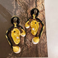 Ear shaped earrings with tassels and pearl earrings
